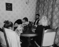 Vier Personen sitzen am Tisch bei einem Escape Room